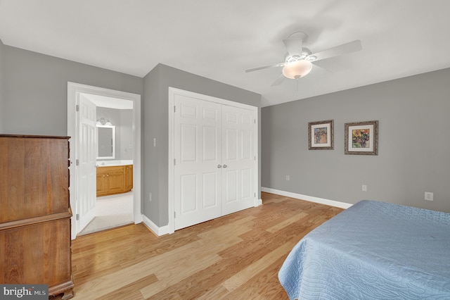 bedroom featuring light wood-type flooring, ceiling fan, a closet, and ensuite bath