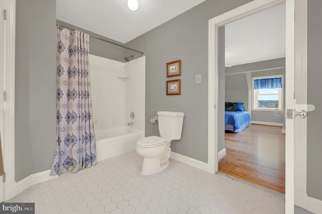 bathroom featuring toilet, tile patterned flooring, and shower / bath combo with shower curtain