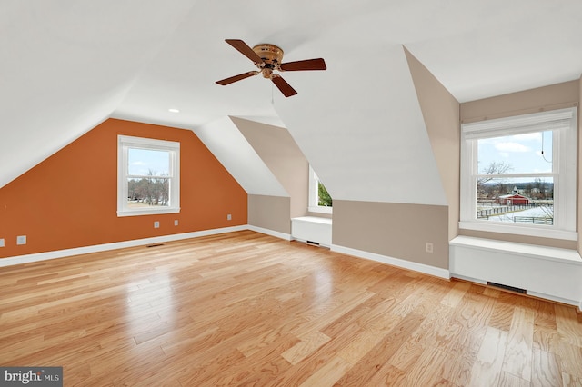 additional living space featuring ceiling fan, lofted ceiling, and light wood-type flooring