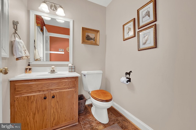 bathroom with toilet and vanity