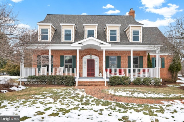 new england style home with covered porch