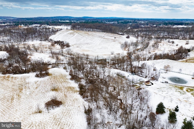 snowy aerial view with a mountain view