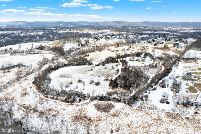 snowy aerial view featuring a mountain view