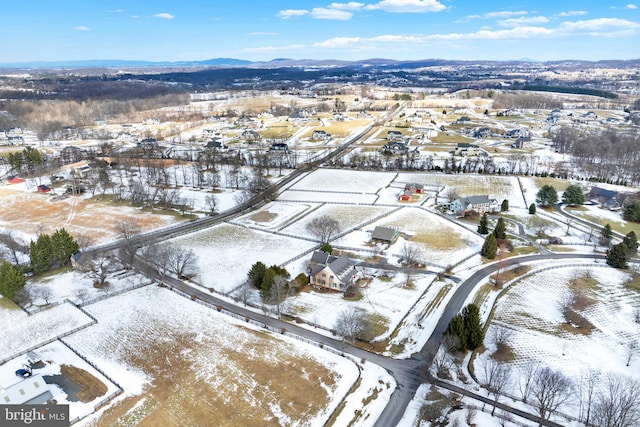 snowy aerial view featuring a mountain view