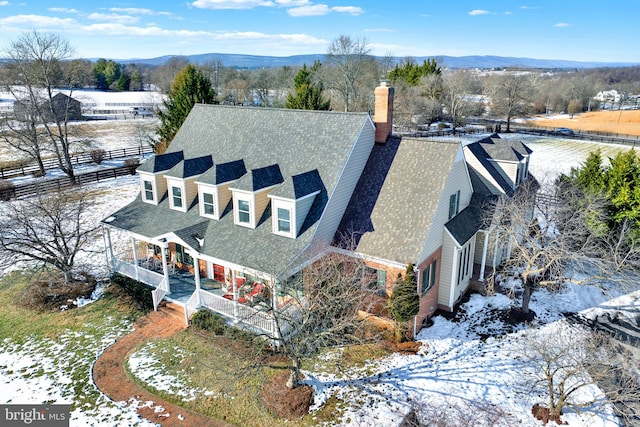 snowy aerial view featuring a mountain view