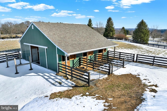 view of stable with a rural view