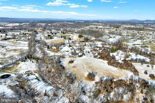 snowy aerial view with a mountain view