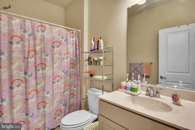 bathroom featuring vanity, toilet, and a shower with shower curtain