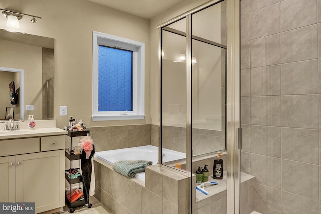 bathroom with shower with separate bathtub and vanity