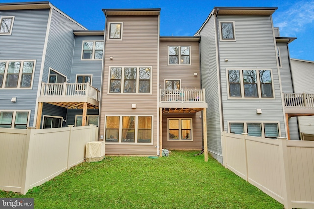 rear view of property with a lawn