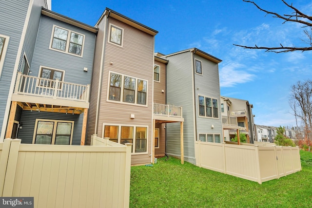 rear view of property with a lawn