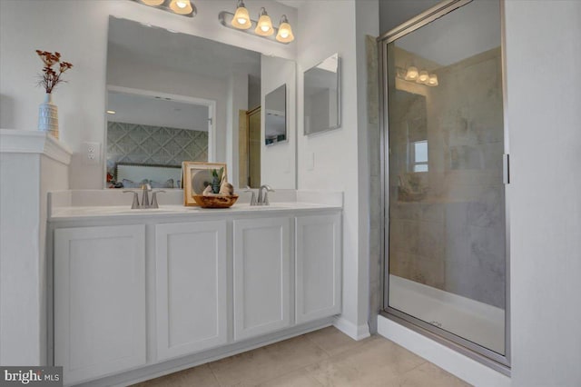 bathroom with tile patterned flooring, vanity, and walk in shower