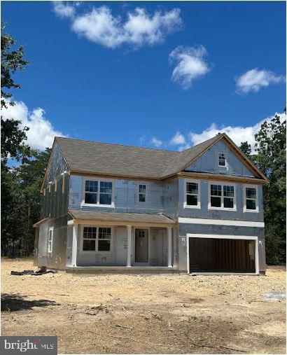 view of front of property featuring a porch and a garage