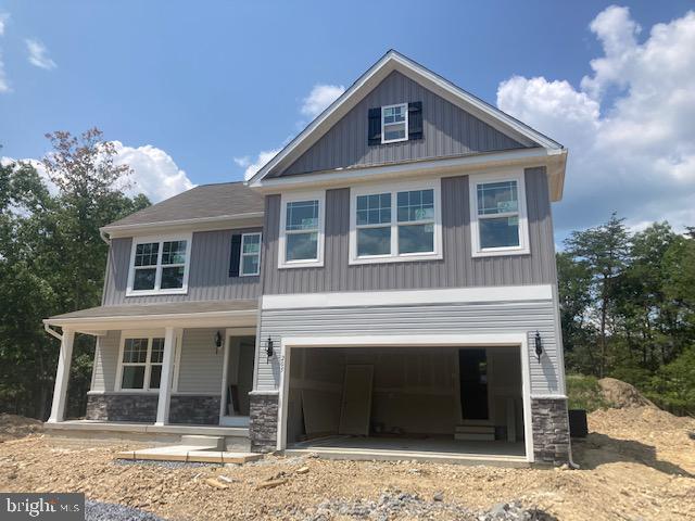 craftsman inspired home with a porch and a garage