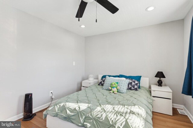 bedroom with ceiling fan and light wood-type flooring