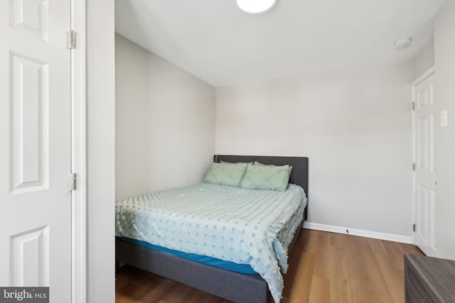 bedroom with hardwood / wood-style flooring