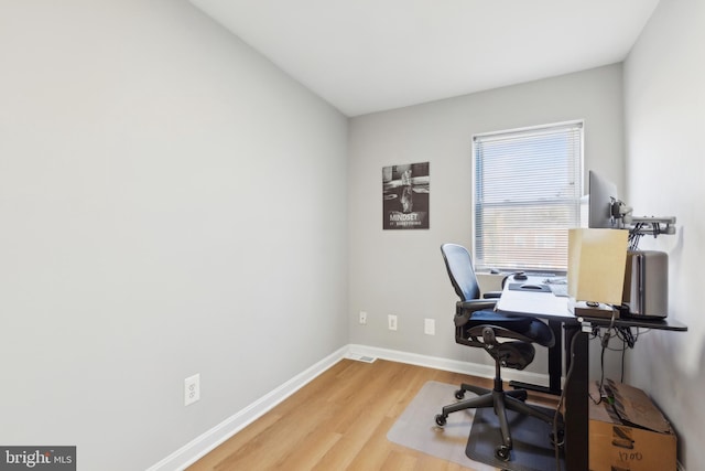 home office with wood-type flooring