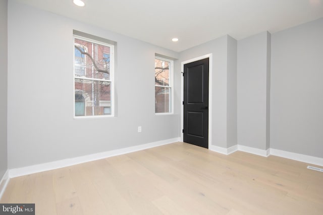 spare room featuring light hardwood / wood-style flooring