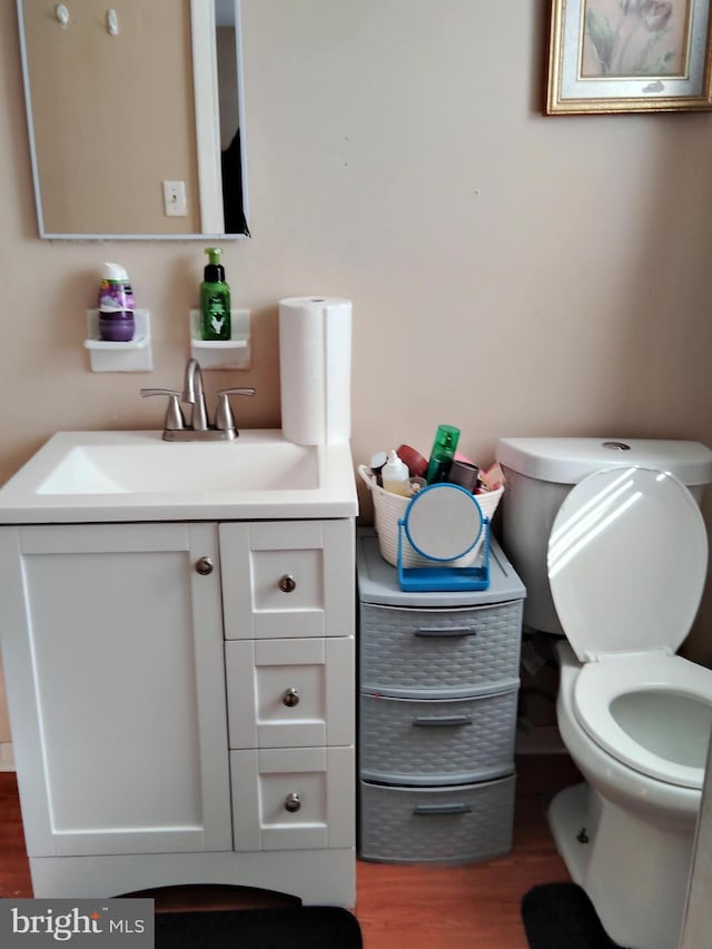 bathroom featuring hardwood / wood-style floors, vanity, and toilet