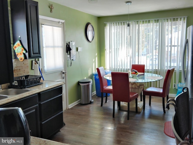 dining room featuring dark hardwood / wood-style flooring, plenty of natural light, and sink