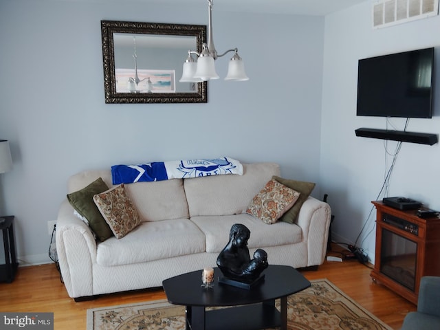 living room featuring a chandelier and hardwood / wood-style flooring