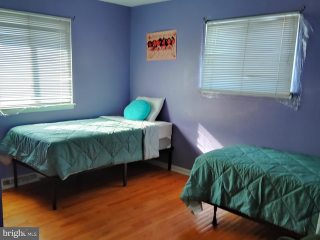 bedroom with hardwood / wood-style flooring