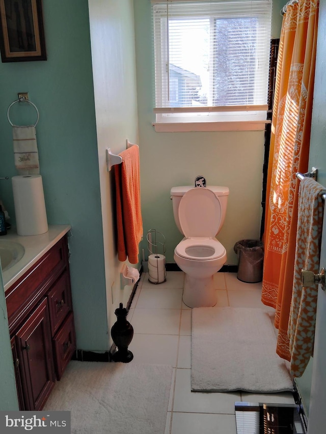 bathroom featuring tile patterned floors, vanity, and toilet