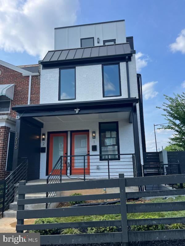 contemporary house featuring covered porch