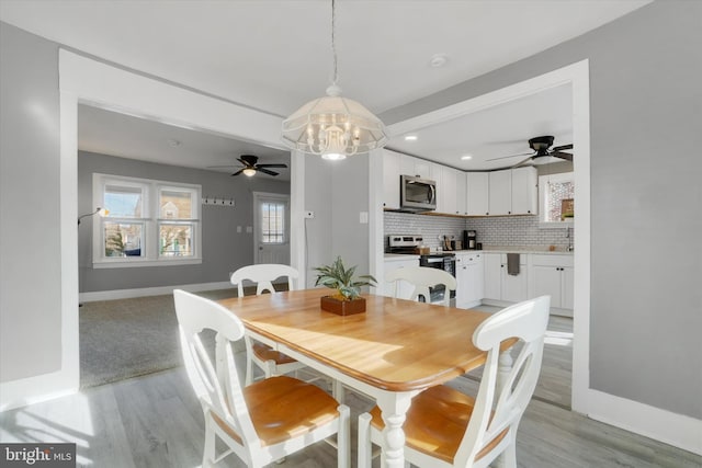 dining space with sink and light hardwood / wood-style flooring