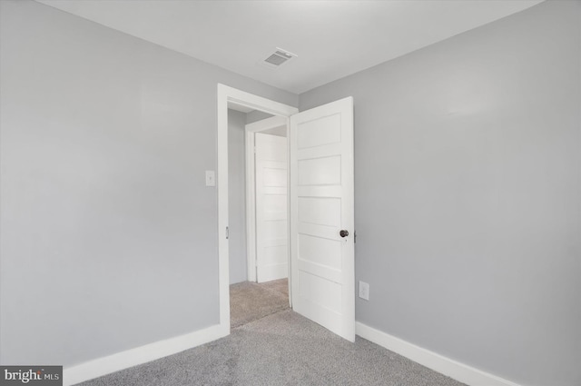 empty room featuring light carpet