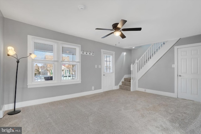 interior space with ceiling fan and carpet flooring