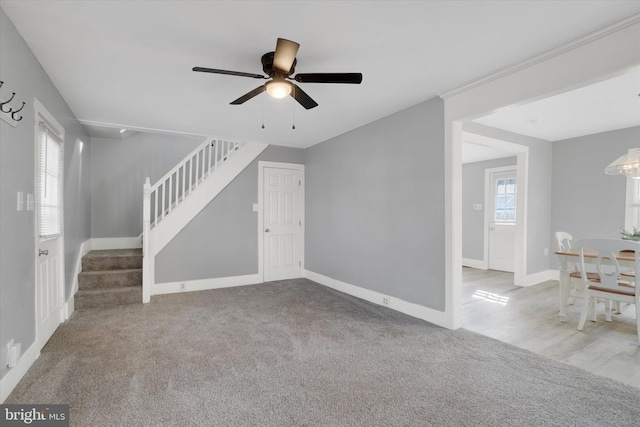 unfurnished living room with ceiling fan and light colored carpet