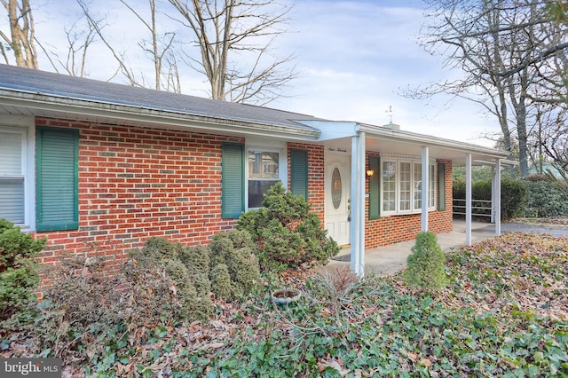 view of side of home featuring covered porch