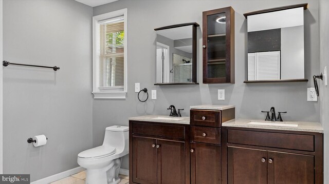 bathroom featuring tile patterned flooring, vanity, and toilet