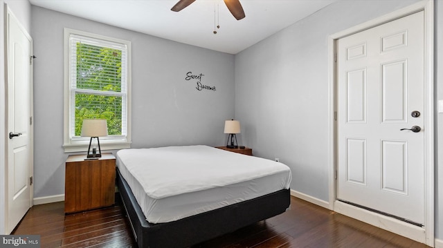 bedroom with ceiling fan and dark hardwood / wood-style floors