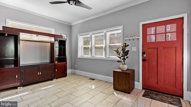 foyer featuring ceiling fan and crown molding