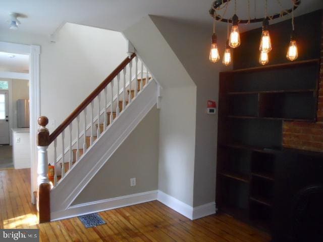 staircase with hardwood / wood-style floors