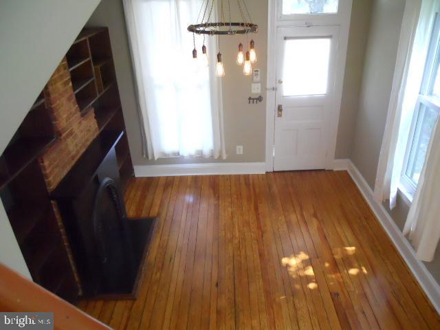 foyer featuring hardwood / wood-style floors and a chandelier