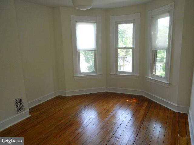 empty room with dark wood-type flooring