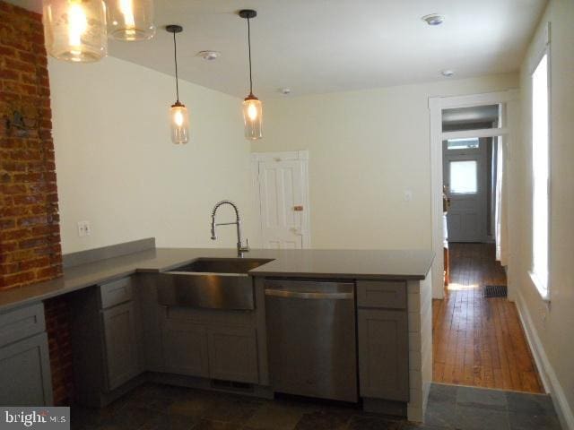 kitchen featuring sink, hanging light fixtures, stainless steel dishwasher, kitchen peninsula, and gray cabinets