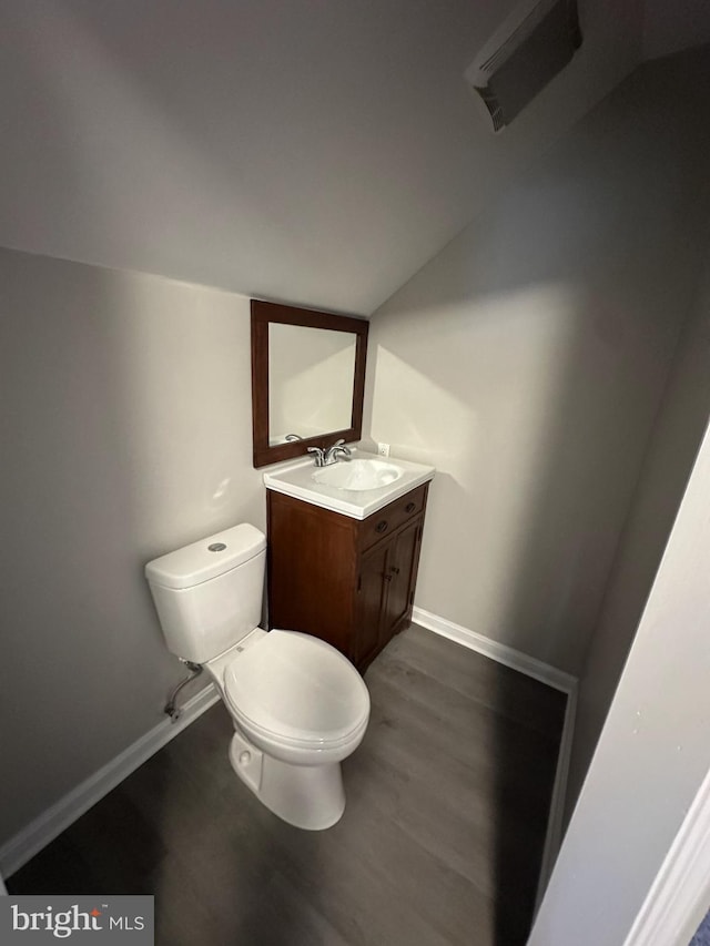 bathroom with hardwood / wood-style flooring, vanity, and toilet