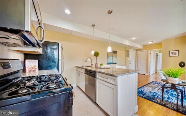 kitchen featuring black range with gas cooktop, sink, dishwasher, white cabinets, and hanging light fixtures