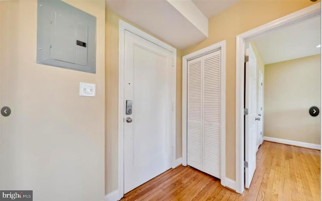 hall featuring electric panel and light hardwood / wood-style flooring