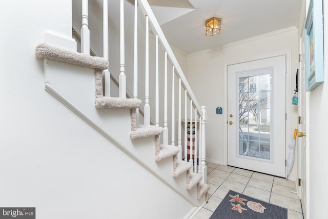 tiled foyer with ornamental molding