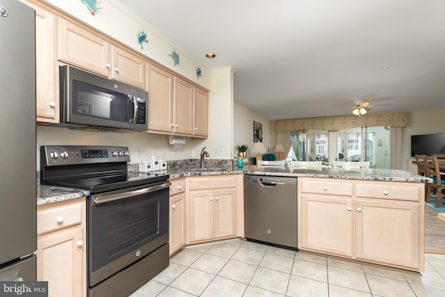 kitchen with appliances with stainless steel finishes, light brown cabinetry, sink, kitchen peninsula, and light stone countertops