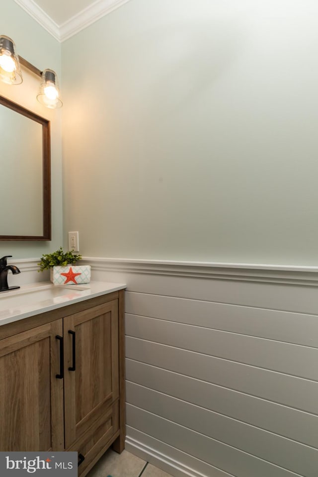 bathroom with vanity, tile patterned flooring, and crown molding