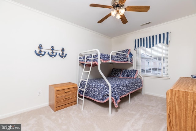 bedroom featuring crown molding, carpet flooring, and ceiling fan