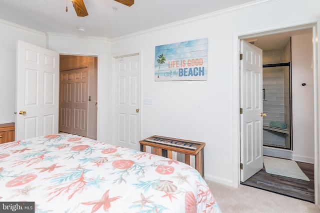 carpeted bedroom featuring ornamental molding, ceiling fan, and a closet