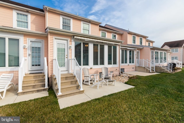 back of house featuring a yard and a patio area