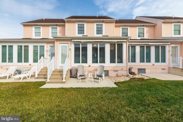 back of house with a lawn and a patio area